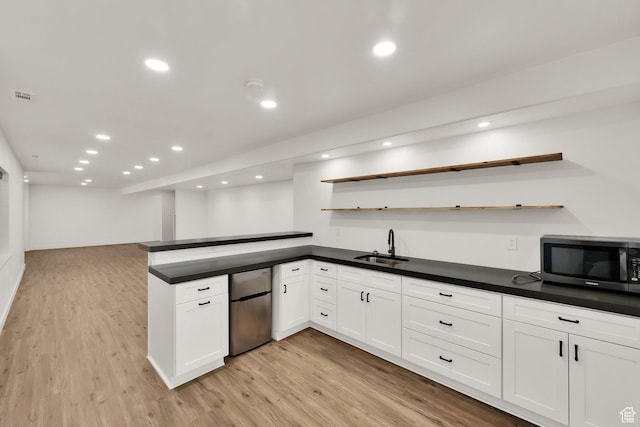 3179 W Hayden Ridge Way S, Riverton, UT 84065 - kitchen featuring fridge, open shelves, dark countertops, light wood-type flooring, and recessed lighting