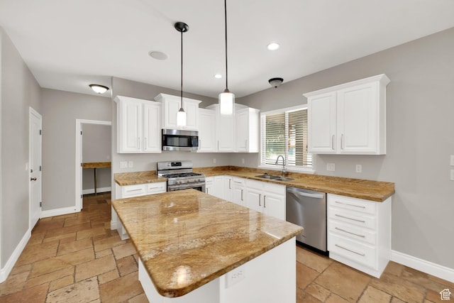 3179 W Hayden Ridge Way S, Riverton, UT 84065 - kitchen featuring appliances with stainless steel finishes, stone tile floors, a kitchen island, white cabinetry, and pendant lighting