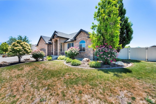 3179 W Hayden Ridge Way S, Riverton, UT 84065 - view of front facade with stone siding and a gate