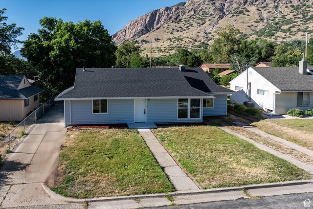 1302 E Harrop S, Ogden, UT 84404 - view of front facade featuring a mountain view and roof with shingles
