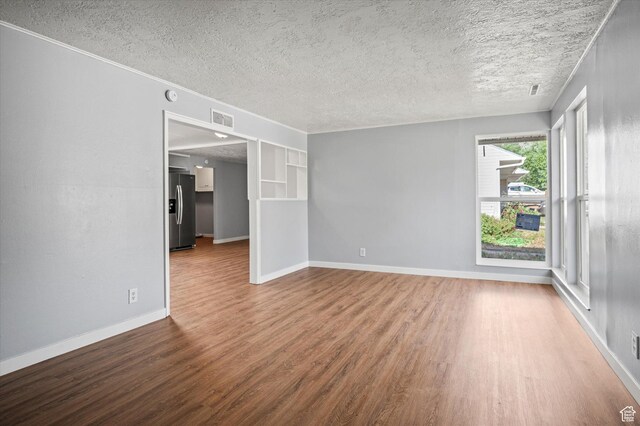 1302 E Harrop S, Ogden, UT 84404 - spare room featuring wood finished floors and a textured ceiling
