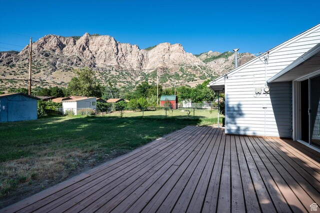 1302 E Harrop S, Ogden, UT 84404 - wooden deck featuring a fenced backyard, a shed, and a mountain view