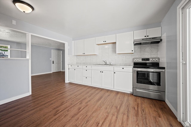 1302 E Harrop S, Ogden, UT 84404 - kitchen with electric stove, under cabinet range hood, backsplash, dark wood finished floors, and white cabinets