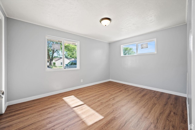 1302 E Harrop S, Ogden, UT 84404 - unfurnished room with wood finished floors and a textured ceiling