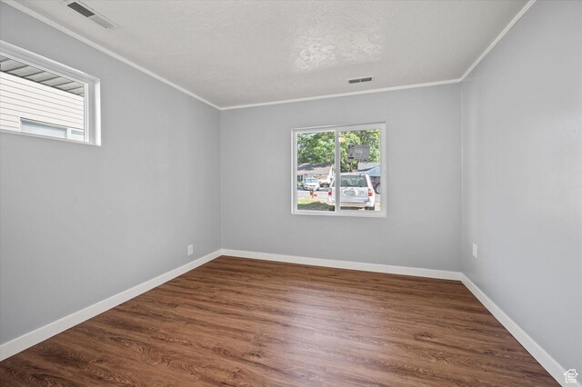 1302 E Harrop S, Ogden, UT 84404 - unfurnished room featuring healthy amount of natural light, ornamental molding, and dark wood finished floors