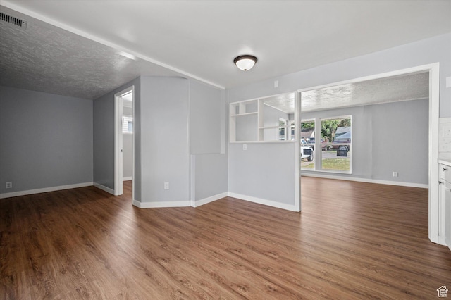 1302 E Harrop S, Ogden, UT 84404 - unfurnished living room with wood finished floors and a textured ceiling