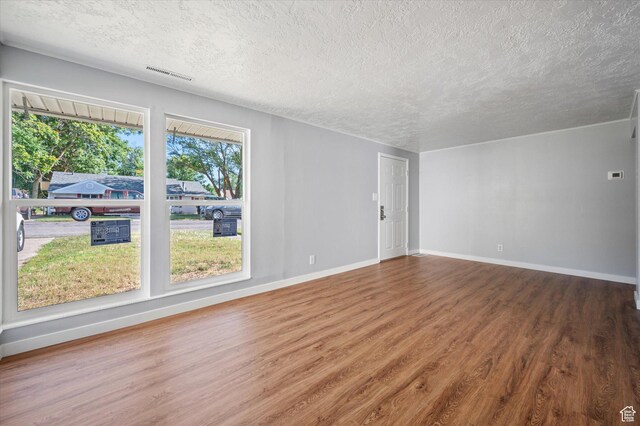 1302 E Harrop S, Ogden, UT 84404 - spare room with a textured ceiling and wood finished floors
