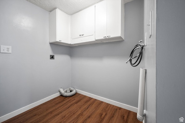1302 E Harrop S, Ogden, UT 84404 - laundry room featuring hookup for an electric dryer, washer hookup, dark wood-type flooring, cabinet space, and a textured ceiling