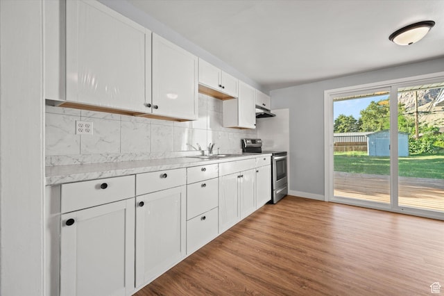 1302 E Harrop S, Ogden, UT 84404 - kitchen featuring stainless steel electric range, under cabinet range hood, wood finished floors, decorative backsplash, and white cabinetry