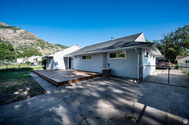 1302 E Harrop S, Ogden, UT 84404 - rear view of house featuring a deck with mountain view and roof with shingles