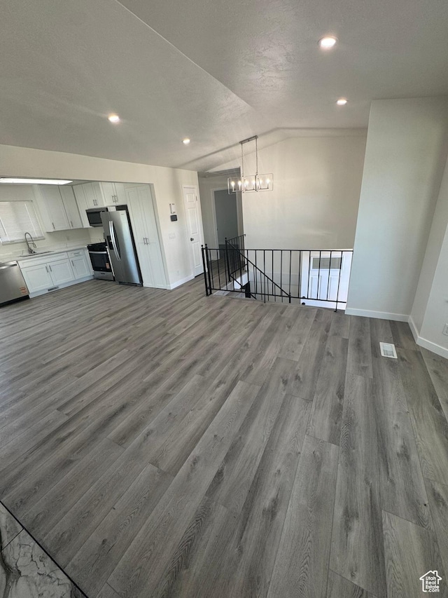 3923 W 5820 S, Taylorsville, UT 84118 - unfurnished living room with a chandelier, dark wood-type flooring, and recessed lighting