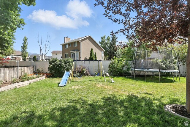 433 W 2425 N, Harrisville, UT 84414 - fenced backyard featuring a trampoline and a vegetable garden