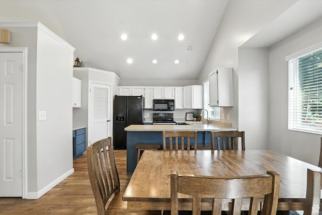 433 W 2425 N, Harrisville, UT 84414 - dining space featuring wood finished floors, vaulted ceiling, and recessed lighting