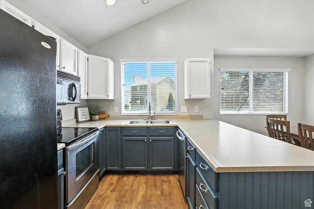 433 W 2425 N, Harrisville, UT 84414 - kitchen with black appliances, a peninsula, white cabinetry, light wood-type flooring, and light countertops