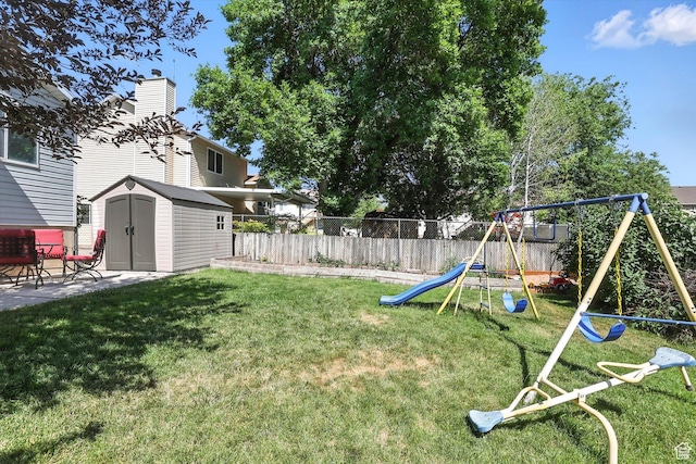 433 W 2425 N, Harrisville, UT 84414 - fenced backyard featuring a playground, a storage unit, and a patio area