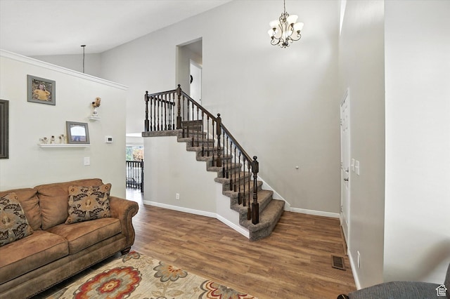 433 W 2425 N, Harrisville, UT 84414 - living room with wood finished floors, stairway, a chandelier, and high vaulted ceiling