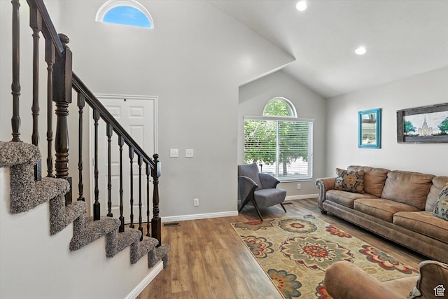 433 W 2425 N, Harrisville, UT 84414 - living room featuring vaulted ceiling, wood finished floors, stairway, and recessed lighting