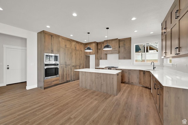3636 N 500 E, North Ogden, UT 84414 - kitchen with stainless steel appliances, light wood-type flooring, a center island, recessed lighting, and light countertops