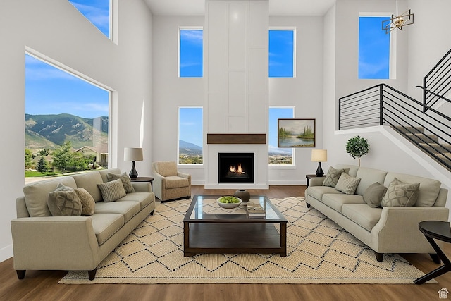 3636 N 500 E, North Ogden, UT 84414 - living room with a mountain view, wood finished floors, a towering ceiling, a large fireplace, and stairway