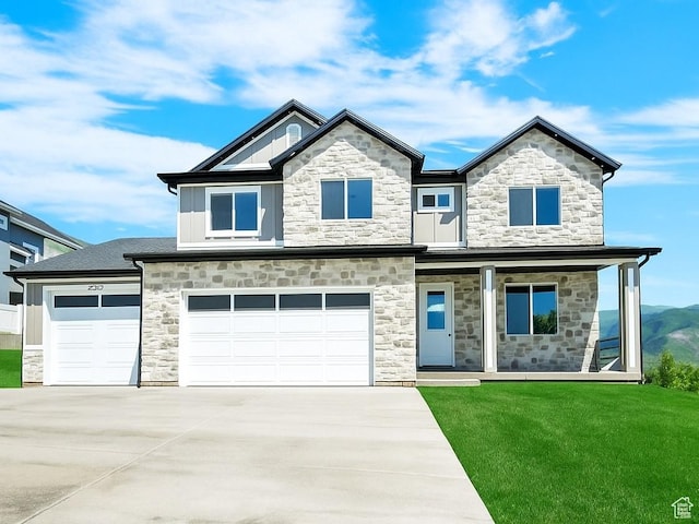 3636 N 500 E, North Ogden, UT 84414 - view of front facade featuring stone siding, a front lawn, driveway, covered porch, and an attached garage