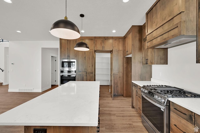 3636 N 500 E, North Ogden, UT 84414 - kitchen featuring appliances with stainless steel finishes, light wood-style flooring, recessed lighting, a kitchen island, and hanging light fixtures