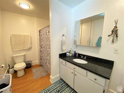 1309 E Hidden Creek Ct S, Holladay, UT 84117 - full bath featuring wood finished floors, vanity, and a shower with shower curtain