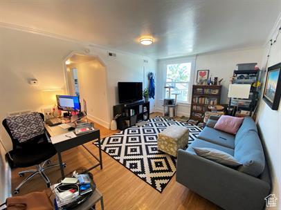 1309 E Hidden Creek Ct S, Holladay, UT 84117 - living room featuring wood finished floors and arched walkways