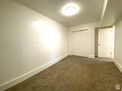 1309 E Hidden Creek Ct S, Holladay, UT 84117 - unfurnished bedroom featuring dark colored carpet and a closet