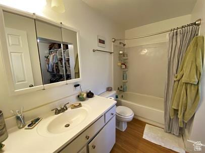 1309 E Hidden Creek Ct S, Holladay, UT 84117 - full bathroom featuring vanity, shower / bath combo with shower curtain, and wood finished floors