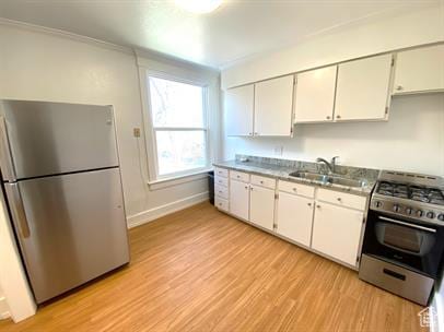 1309 E Hidden Creek Ct S, Holladay, UT 84117 - kitchen featuring appliances with stainless steel finishes, light wood-style floors, white cabinets, and crown molding