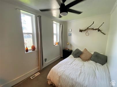 1309 E Hidden Creek Ct S, Holladay, UT 84117 - bedroom featuring multiple windows, ceiling fan, and crown molding