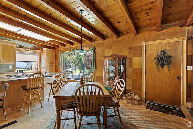2391 Kays Creek Dr, Layton, UT 84040 - dining space with light wood finished floors, a wood ceiling with exposed beams, and wooden walls
