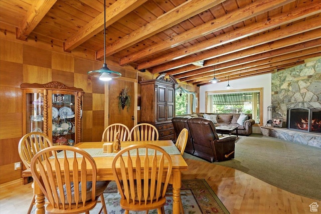 2391 Kays Creek Dr, Layton, UT 84040 - dining room featuring wooden walls, a wooden ceiling with exposed beams, light wood finished floors, and a stone fireplace