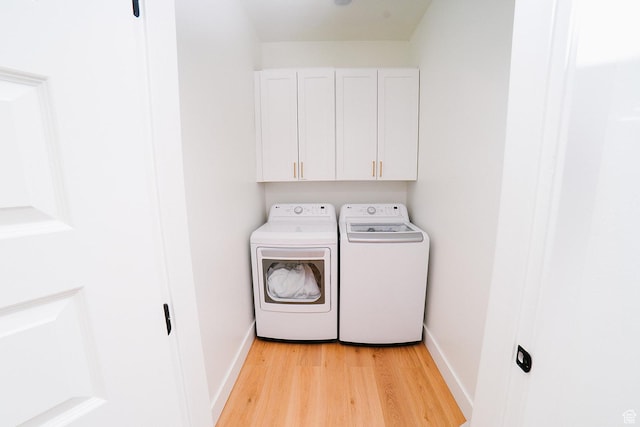 357 W Posies Dr, Garden City, UT 84028 - laundry area featuring independent washer and dryer, light wood-style flooring, and cabinet space