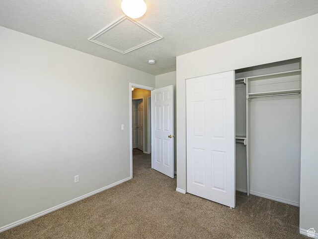 136 W 1980 S, Clearfield, UT 84015 - unfurnished bedroom with attic access, carpet floors, a textured ceiling, and a closet