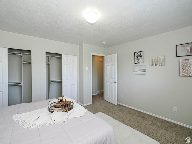 136 W 1980 S, Clearfield, UT 84015 - bedroom featuring multiple closets, carpet floors, and a textured ceiling