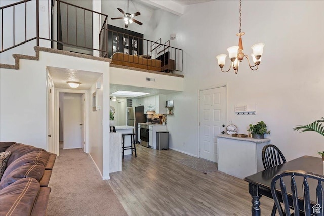 1175 E Canyon Rd Unit 83, Ogden, UT 84404 - living room featuring a ceiling fan, a chandelier, stairs, high vaulted ceiling, and beamed ceiling