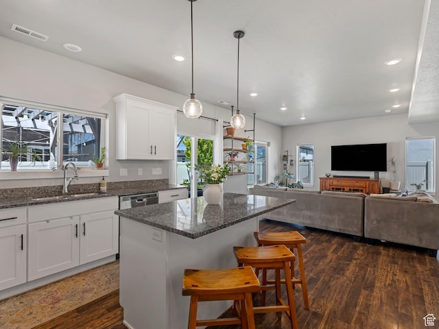 3187 N 3450 W, Plain City, UT 84404 - kitchen with a center island, white cabinetry, recessed lighting, a breakfast bar, and dark stone counters