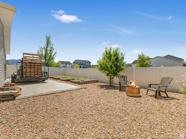3187 N 3450 W, Plain City, UT 84404 - fenced backyard featuring a fire pit, a patio area, and a residential view