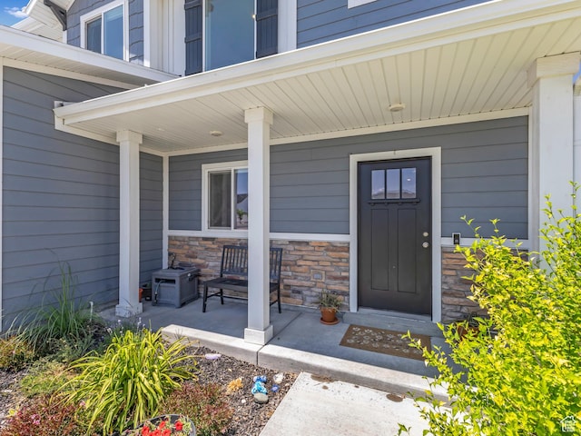 3187 N 3450 W, Plain City, UT 84404 - doorway to property with a porch and stone siding
