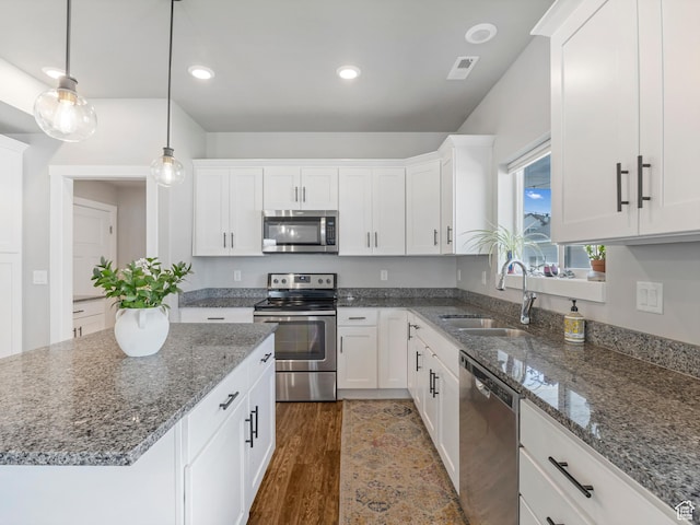 3187 N 3450 W, Plain City, UT 84404 - kitchen with appliances with stainless steel finishes, white cabinets, dark wood finished floors, and recessed lighting