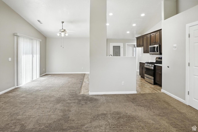 452 E 875 N, Ogden, UT 84404 - kitchen with stainless steel appliances, vaulted ceiling, ceiling fan, dark brown cabinetry, and light carpet