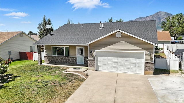 452 E 875 N, Ogden, UT 84404 - view of front of house with brick siding, driveway, roof with shingles, a garage, and a mountain view