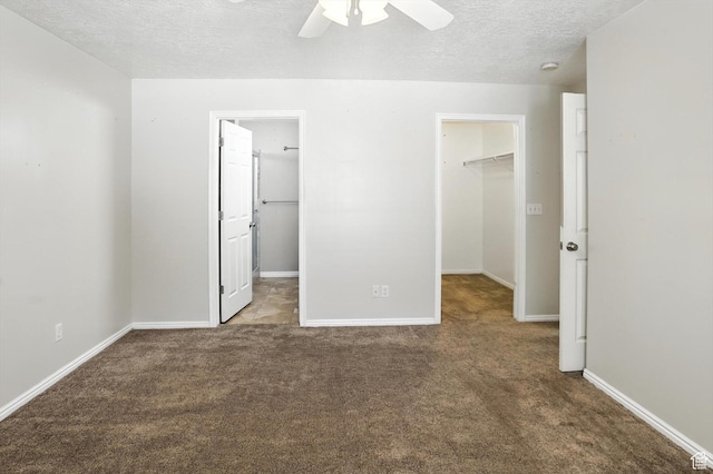 452 E 875 N, Ogden, UT 84404 - unfurnished bedroom featuring a spacious closet, a closet, carpet flooring, a textured ceiling, and a ceiling fan