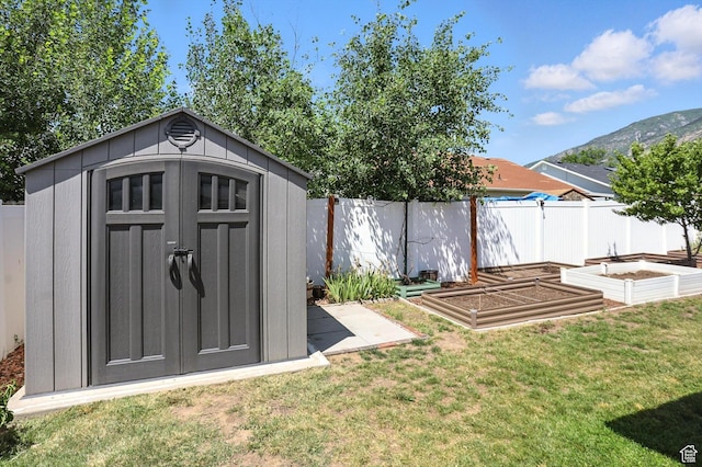 452 E 875 N, Ogden, UT 84404 - view of shed with a vegetable garden, a fenced backyard, and a mountain view
