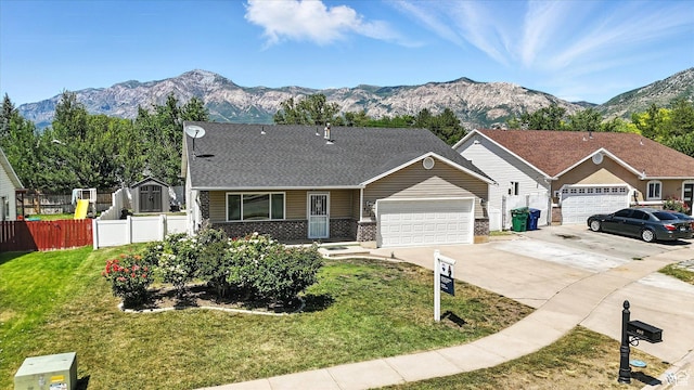 452 E 875 N, Ogden, UT 84404 - view of front of house featuring an attached garage, driveway, a mountain view, and brick siding