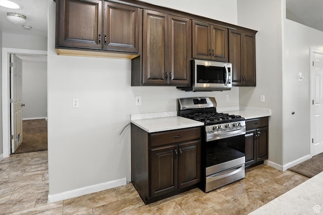 452 E 875 N, Ogden, UT 84404 - kitchen featuring appliances with stainless steel finishes, light countertops, and dark brown cabinets