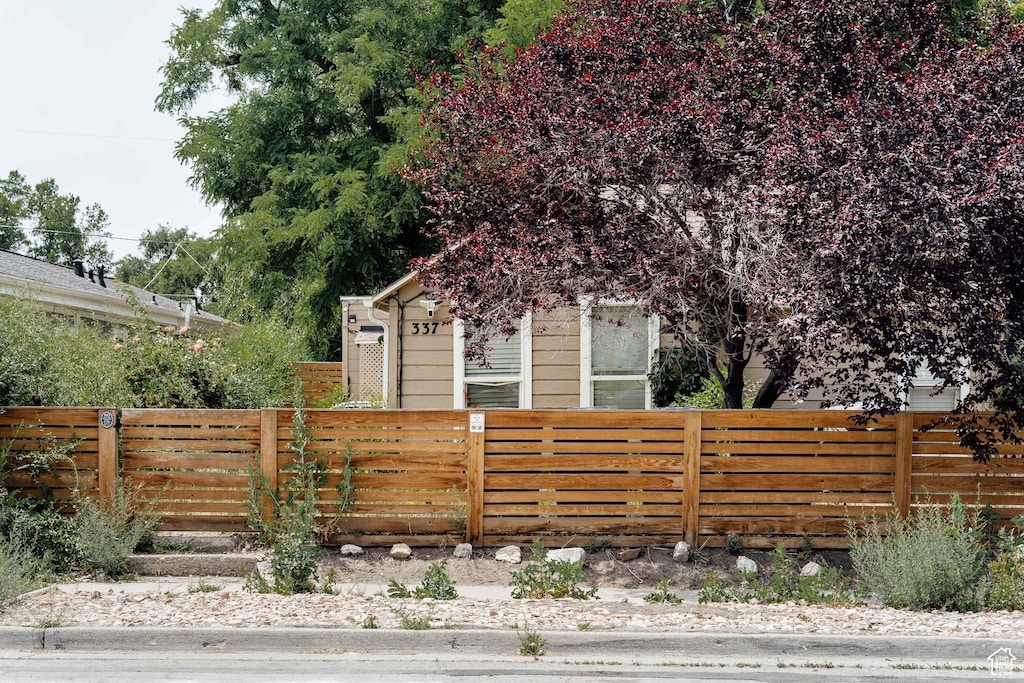 337 N Marion St, Salt Lake City, UT 84116 - view of property hidden behind natural elements featuring a fenced front yard