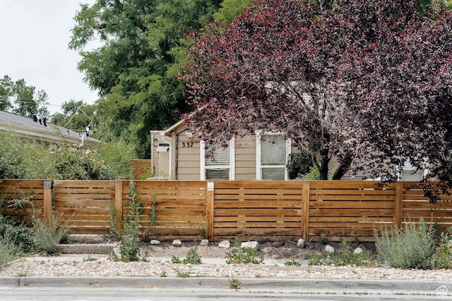 337 N Marion St, Salt Lake City, UT 84116 - view of property hidden behind natural elements featuring a fenced front yard