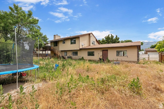 632 S 1150 W, Layton, UT 84041 - back of property with a trampoline, stairway, and a chimney